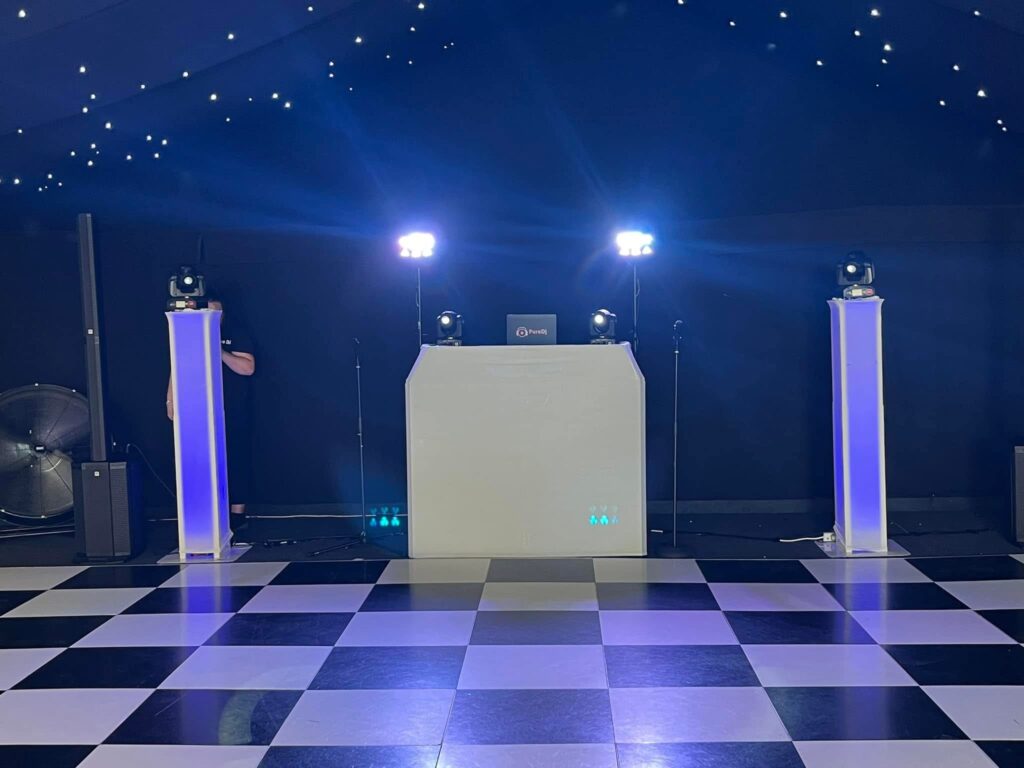     Modern wedding DJ setup with premium sound system and stylish lighting ready for a wedding celebration.